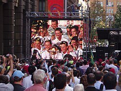 A large crowd of over 10,000 fans welcome the Australian team on completing the first World Cup hat-trick – Martin Place, Sydney.