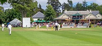 Ellyse Perry batting, Paul Reiffel umpiring at a women's Test match at Bowral, February 2008.